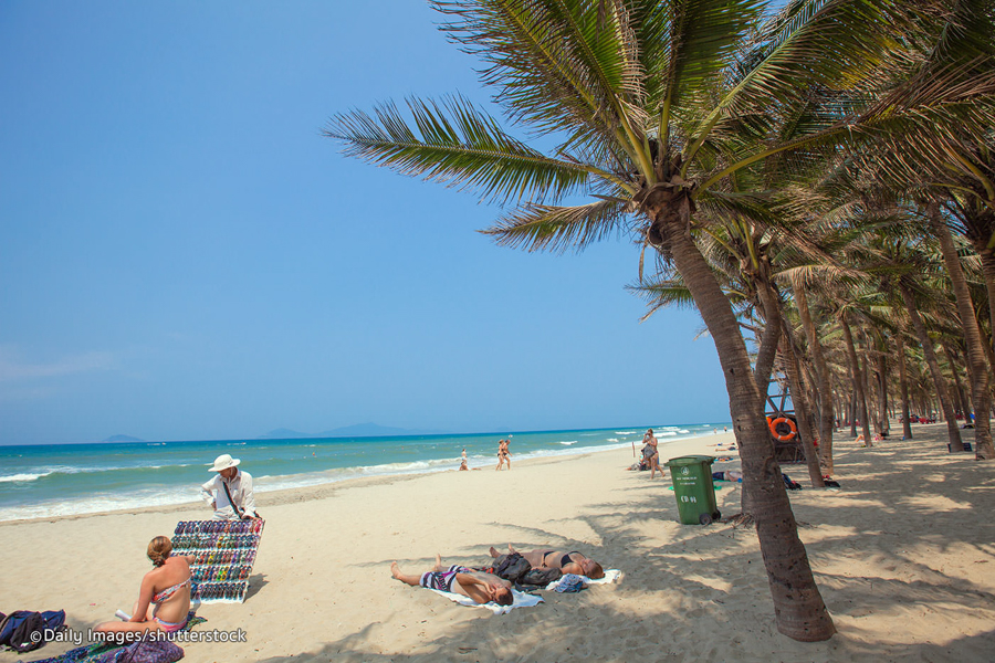 Tourist swimming and sunbathing on  Cua Dai Beach